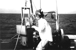 Photograph showing 
scientist collecting samples from the bottom of the Mississippi Sound